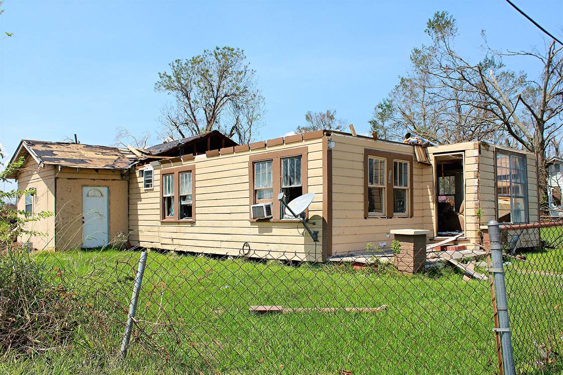 A one-story Lake Charles house with its roof torn off after Hurricane Laura